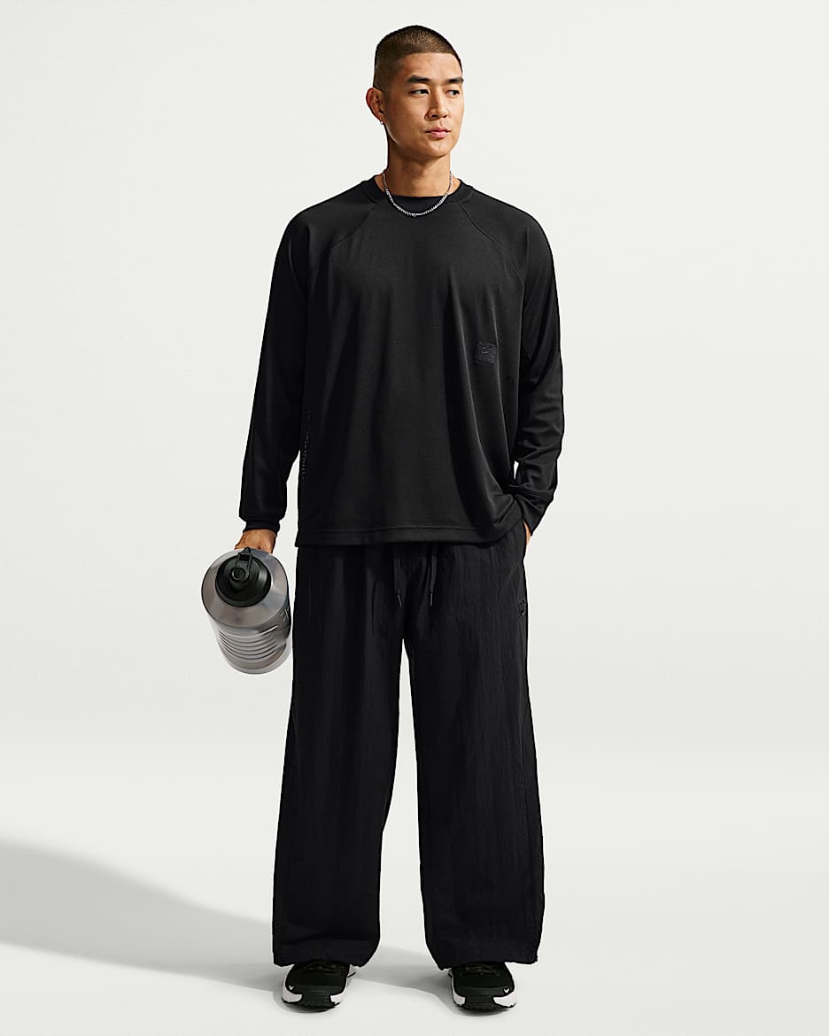 Nike N.A.C. Dri-FIT 男子 Oversize 风速干梭织长裤 - 黑/黑